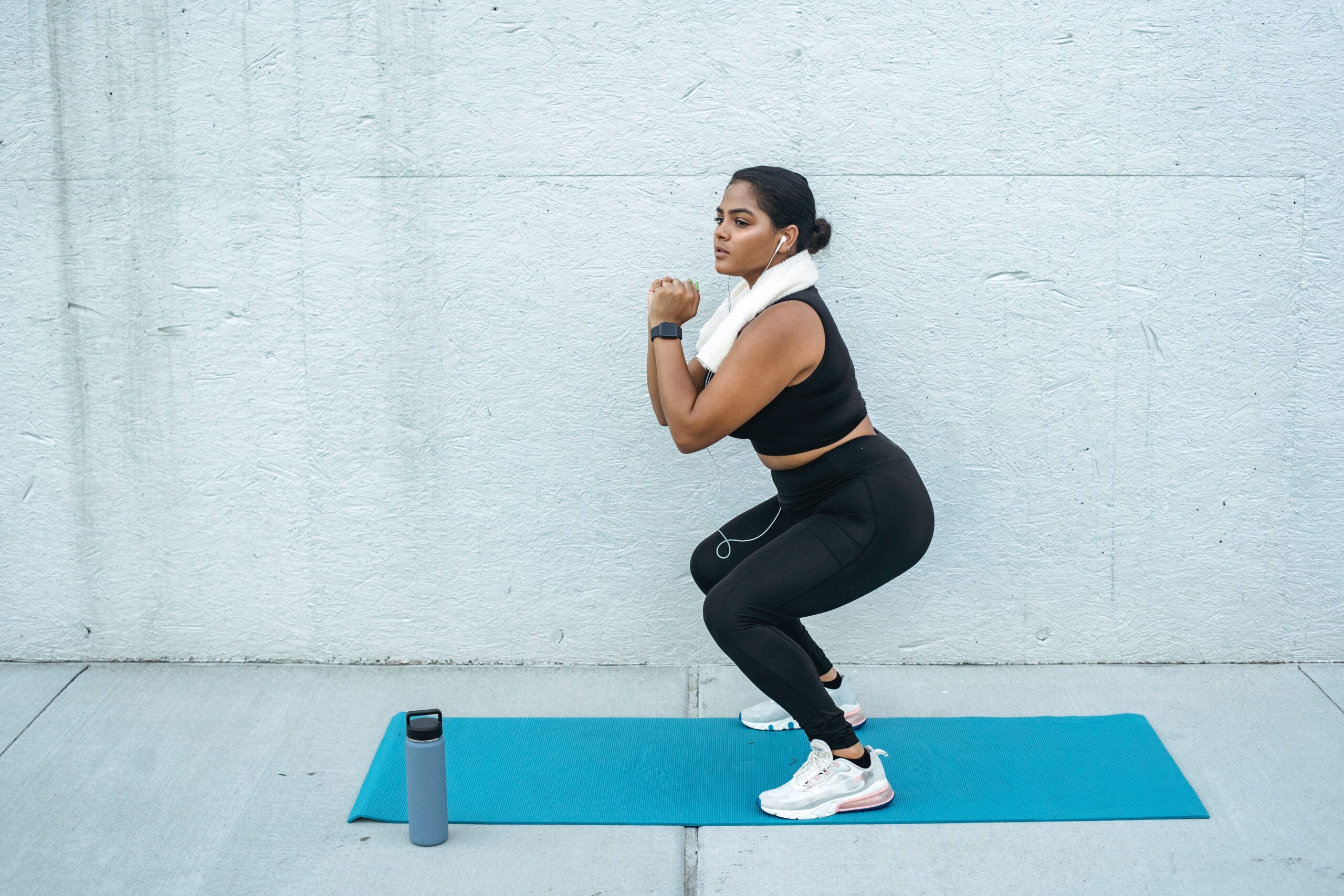 woman doing a squat - benefits of squats